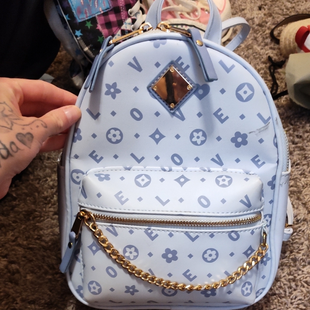 Blue Patterned Backpack with Gold Accents